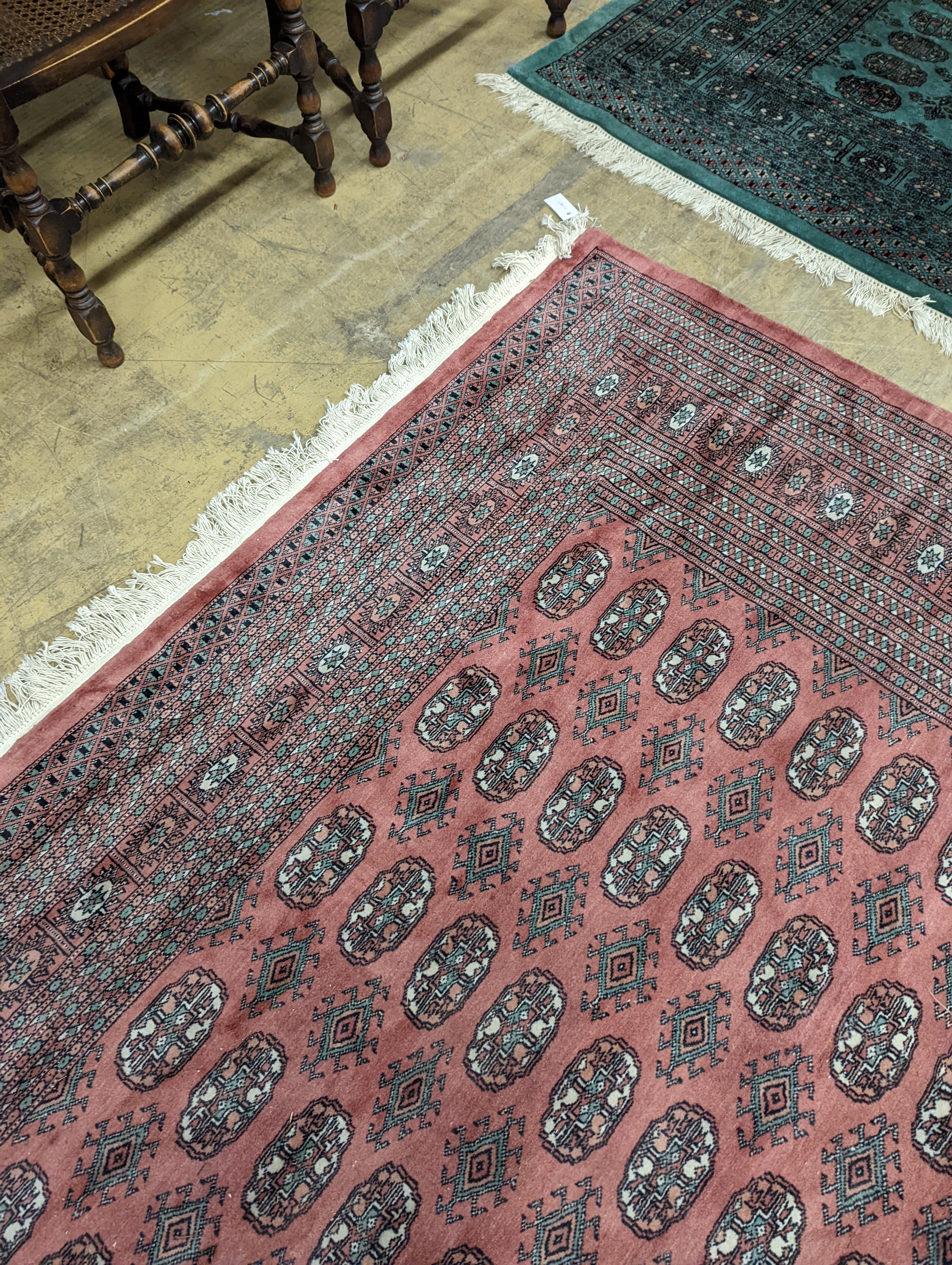 A pink ground Bokhara carpet, 315 x 220cm